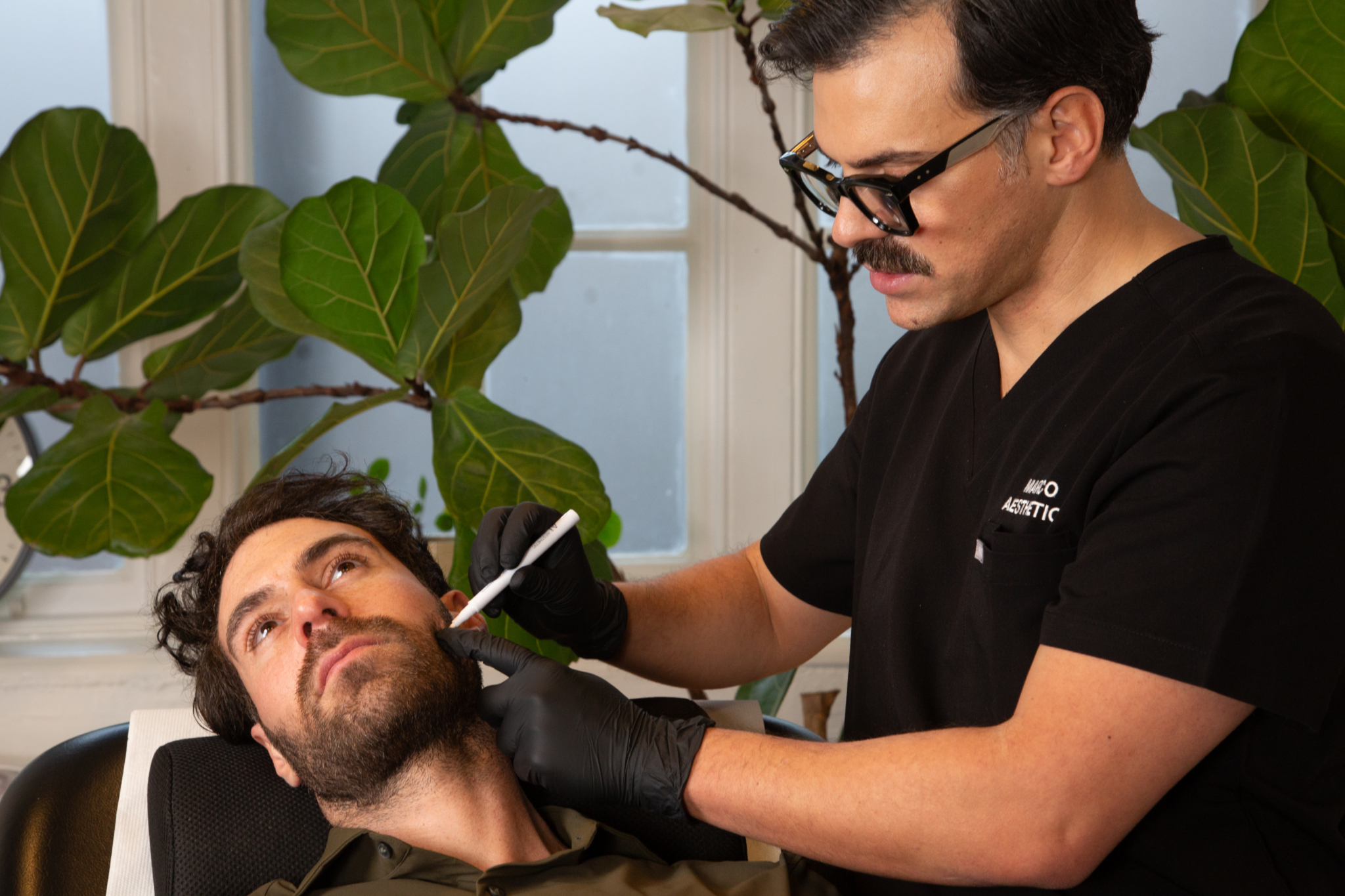 Marco prepares a male client for excessive teeth grinding botox treatment