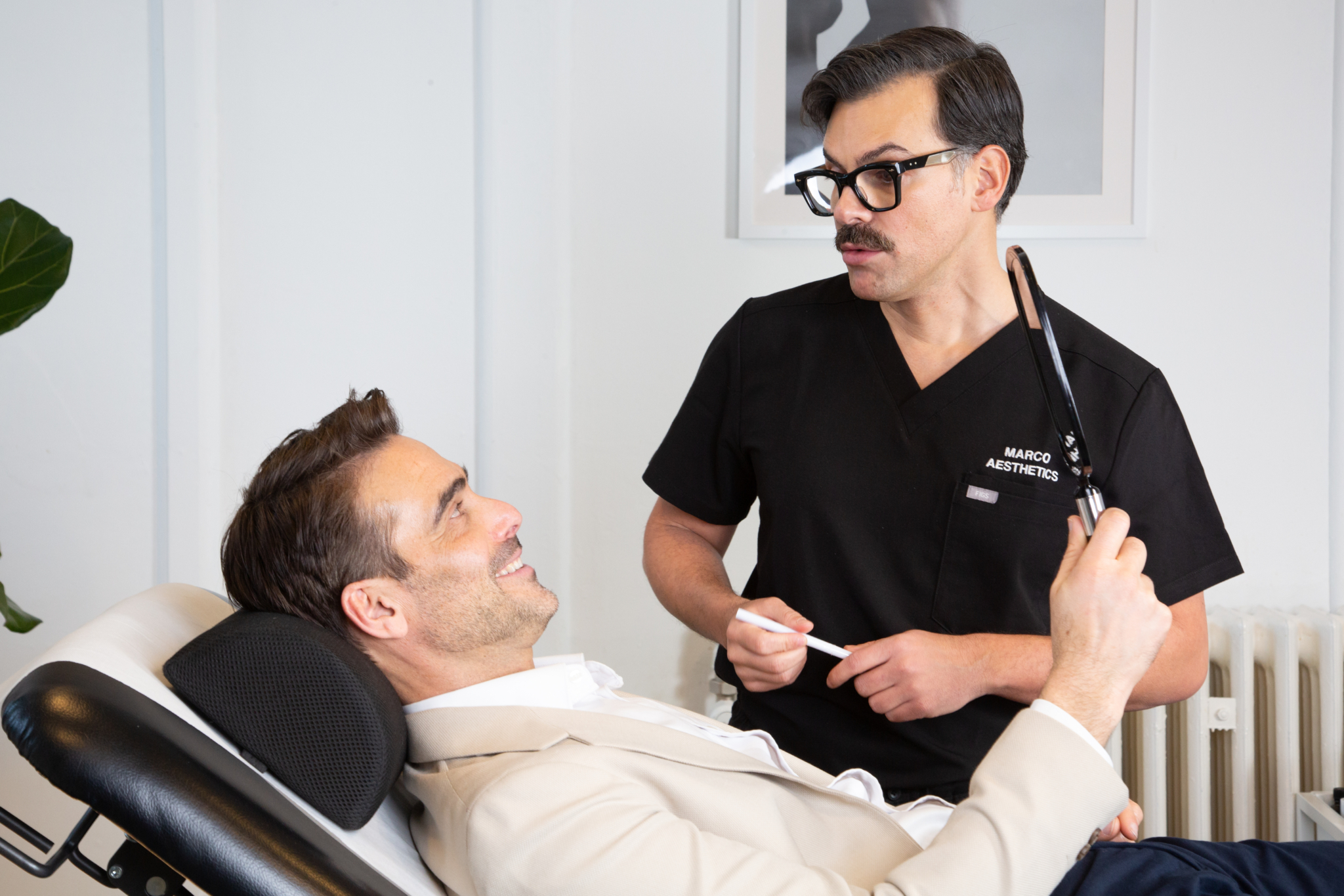 Marco discusses the results of gummy smile treatment with a male client