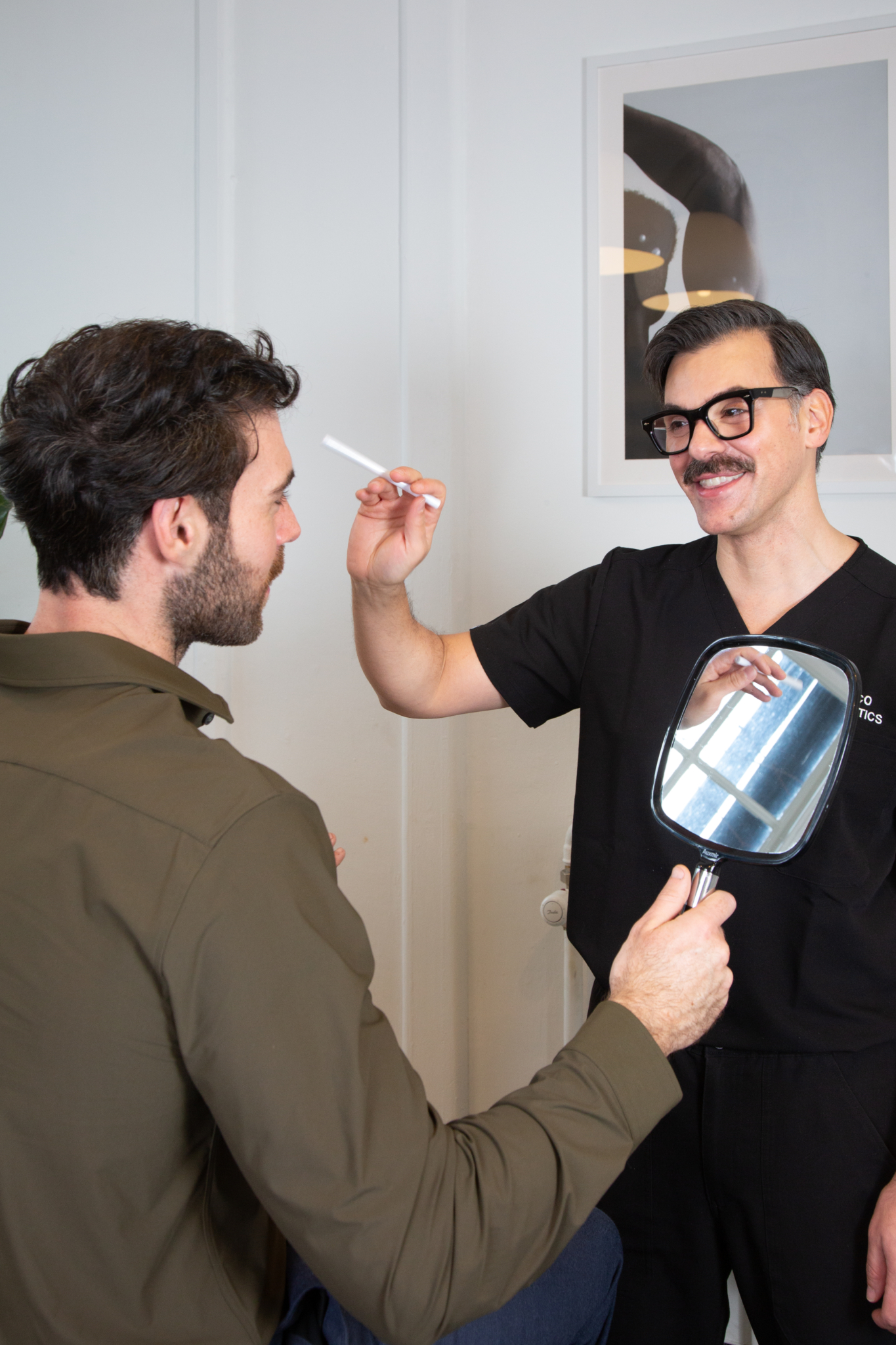 Marco discusses the results of gummy smile treatment with a male client