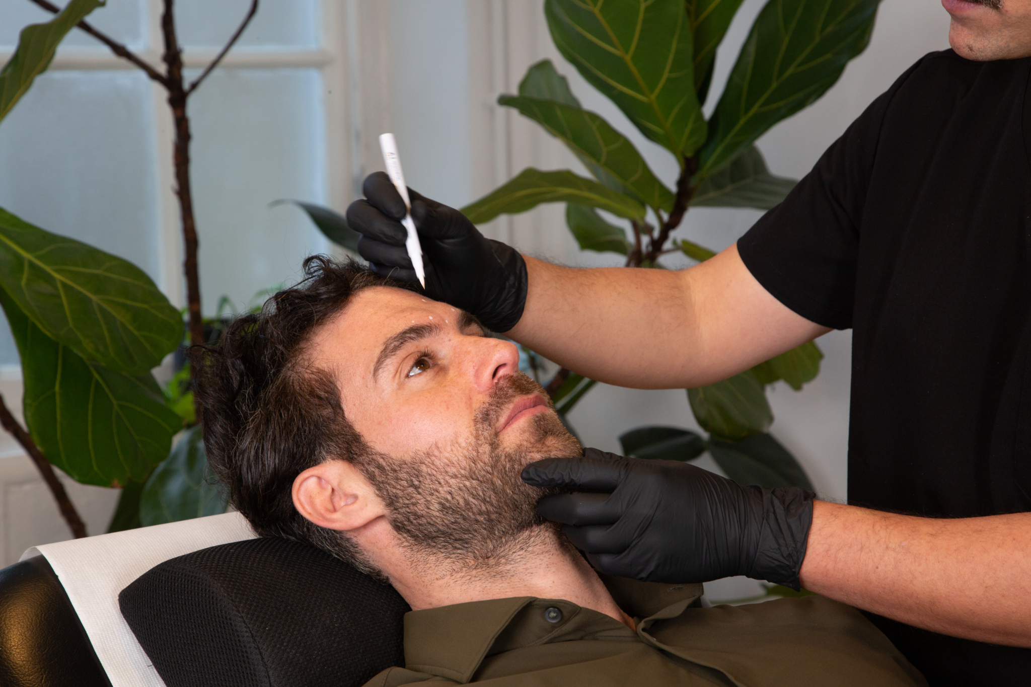 Marco prepares a male client for botox for migraines