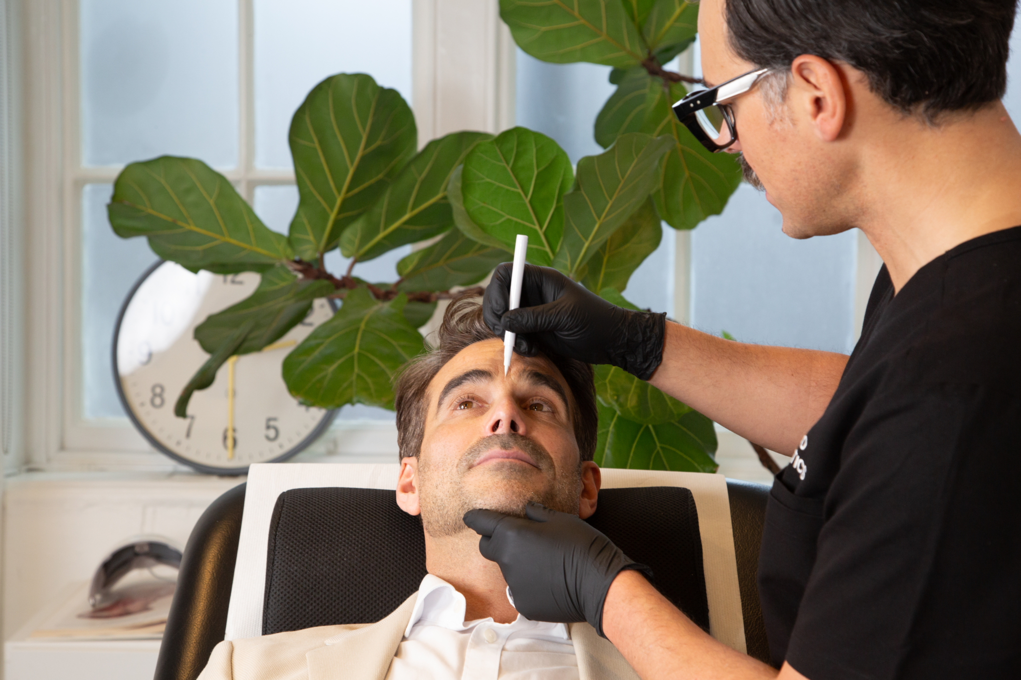 Marco prepares a male client for botox for migraines