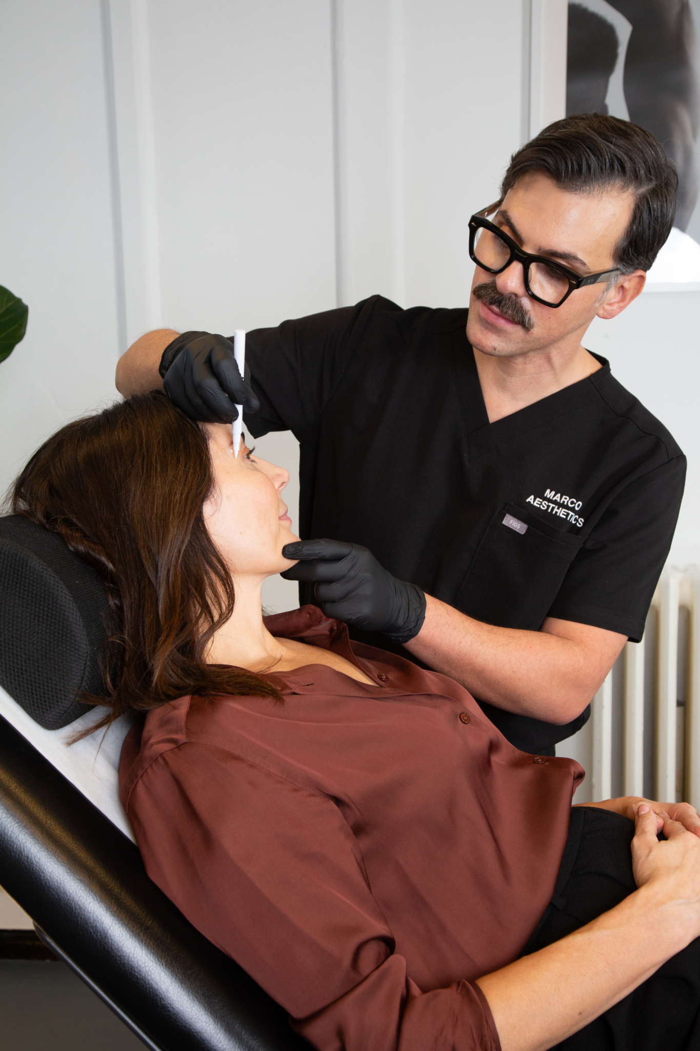 Marco prepares a client for botox for migraines