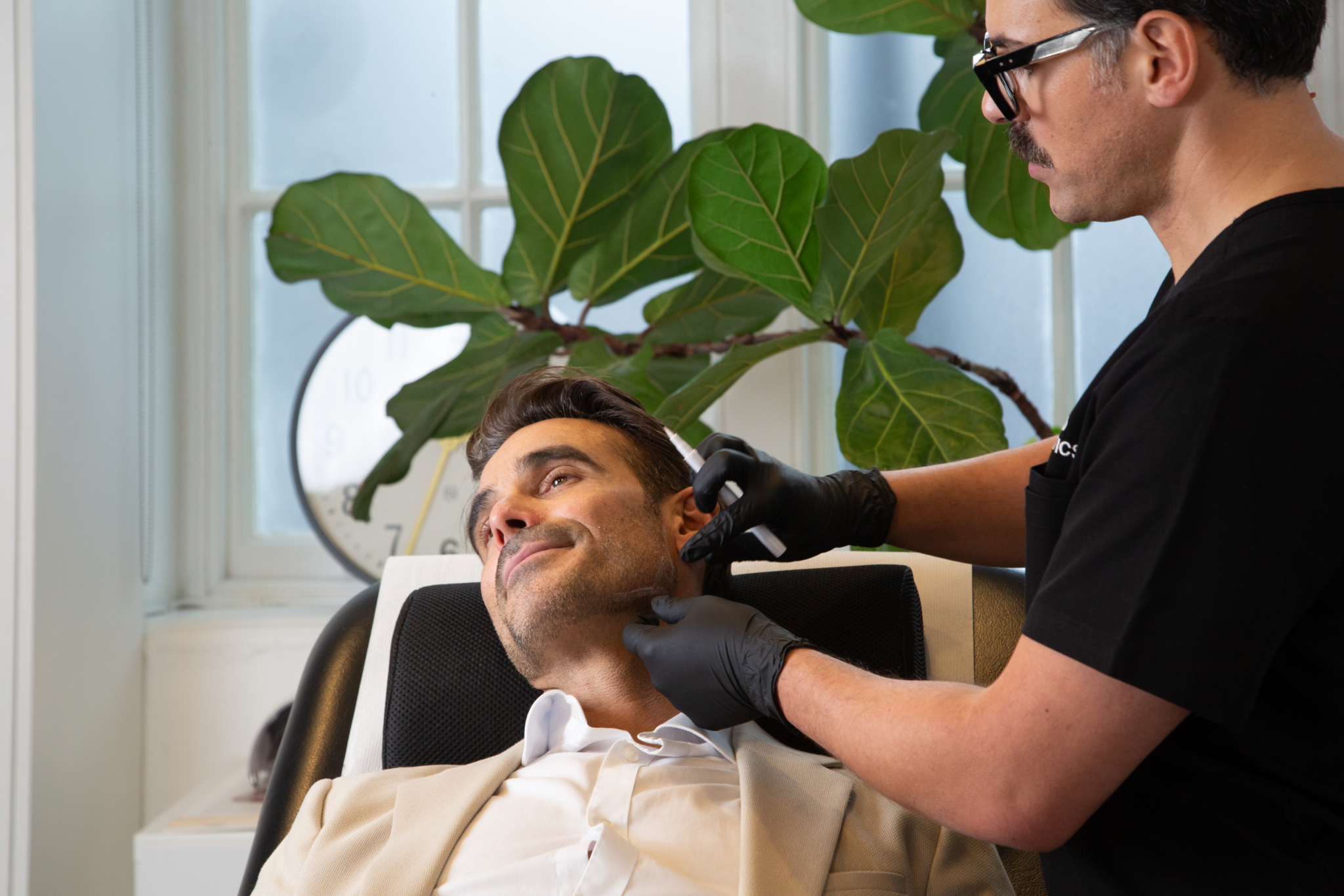 Marco prepares a male client for their jawline filler