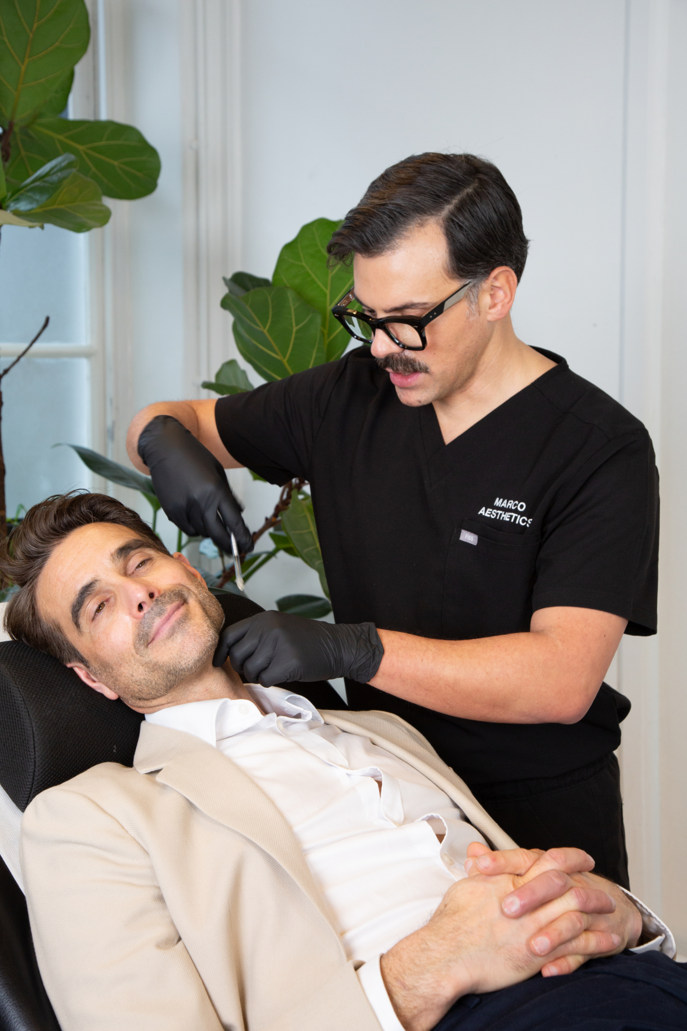 Marco prepares a male client for his jaw filler