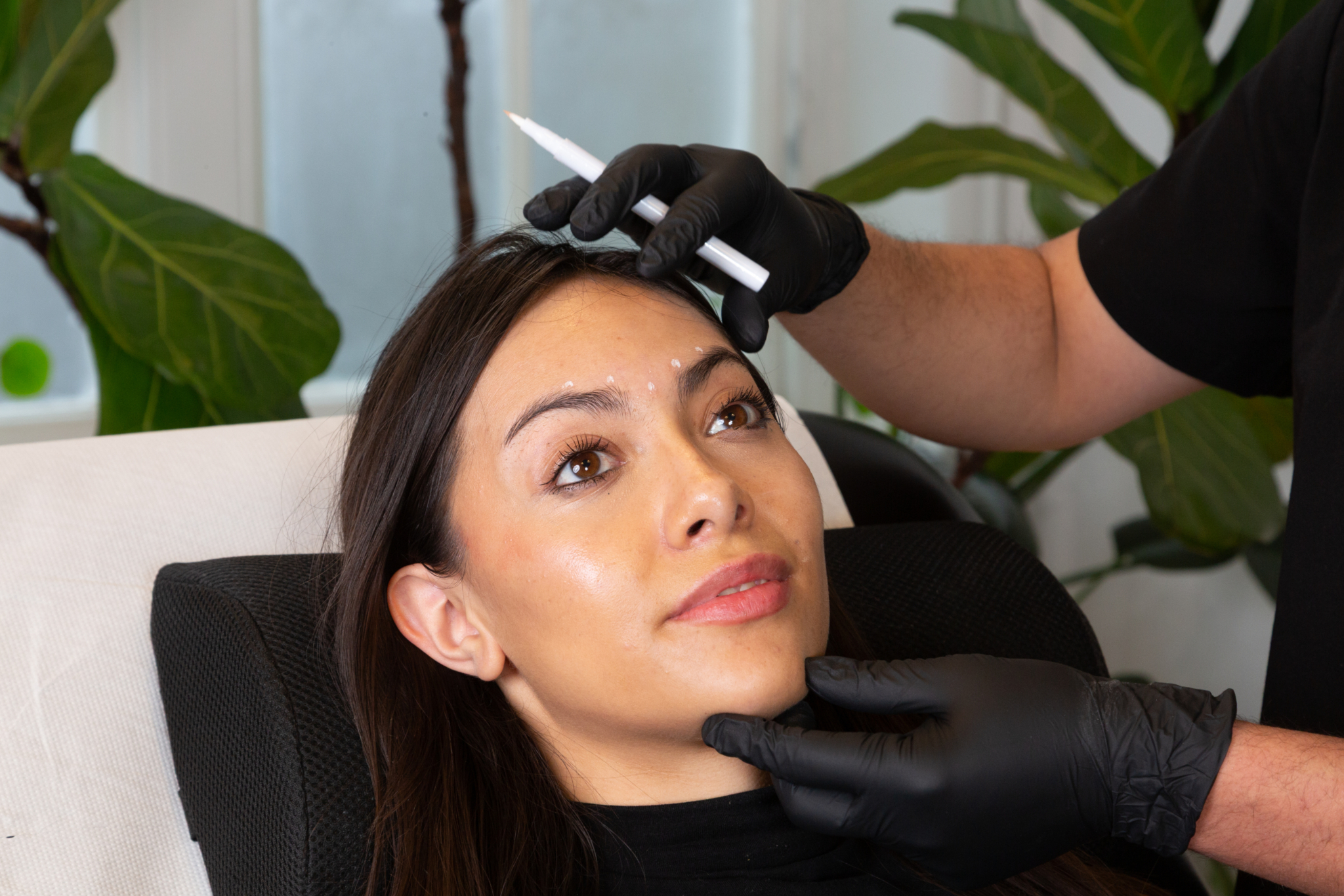 Marco prepares a client for filler treatment in his Shoreditch, London studio