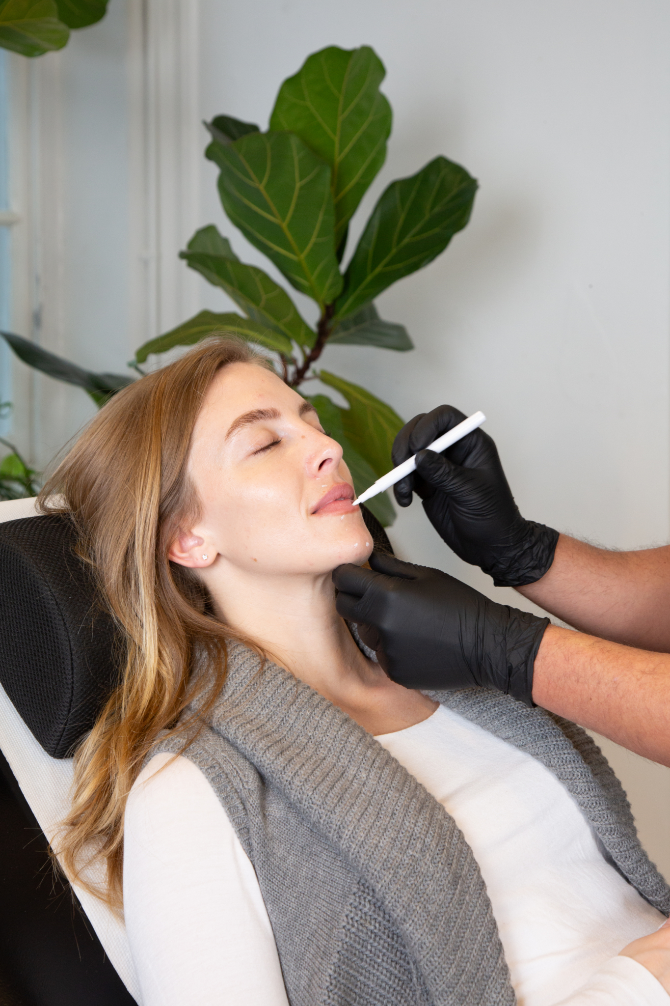 Marco prepares a client for lip filler