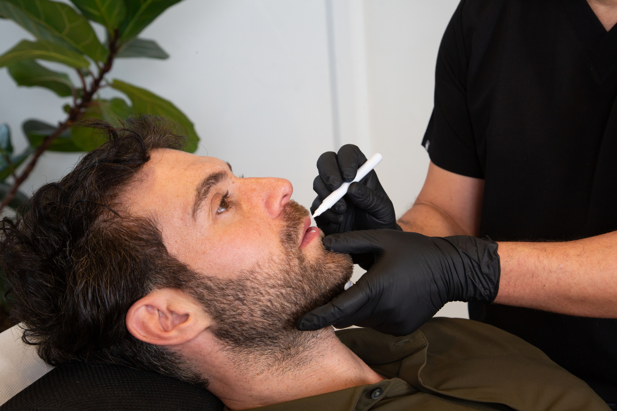 Marco prepares a male client for lip filler