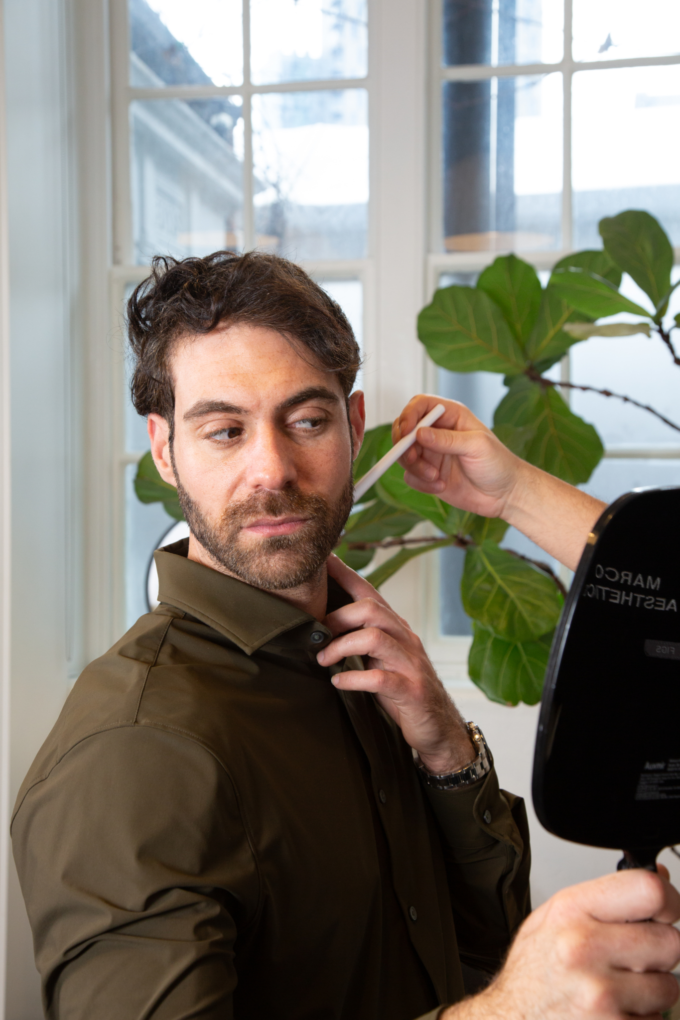 Marco discusses dermal fillers for marionette lines with a male client