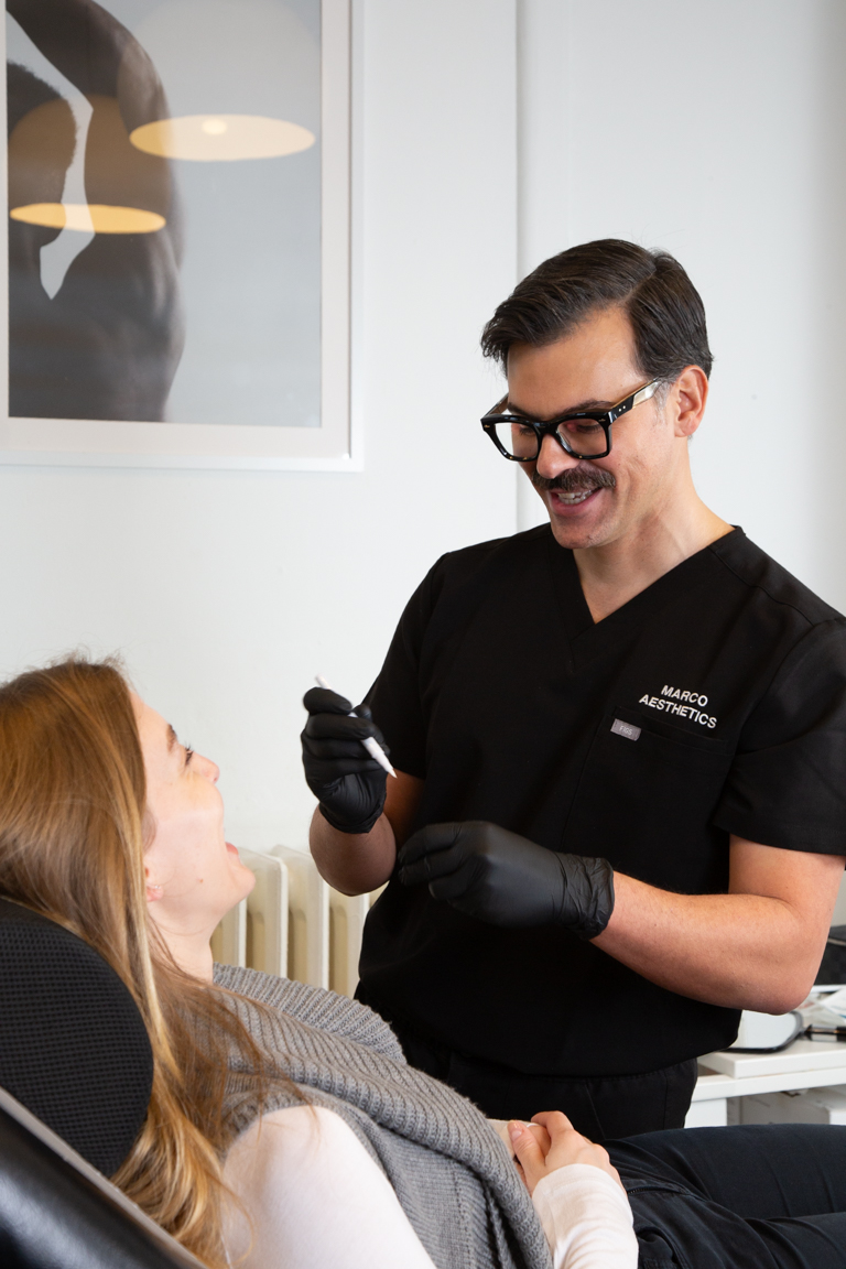 Marco prepares a happy client for their nasolabial folds filler