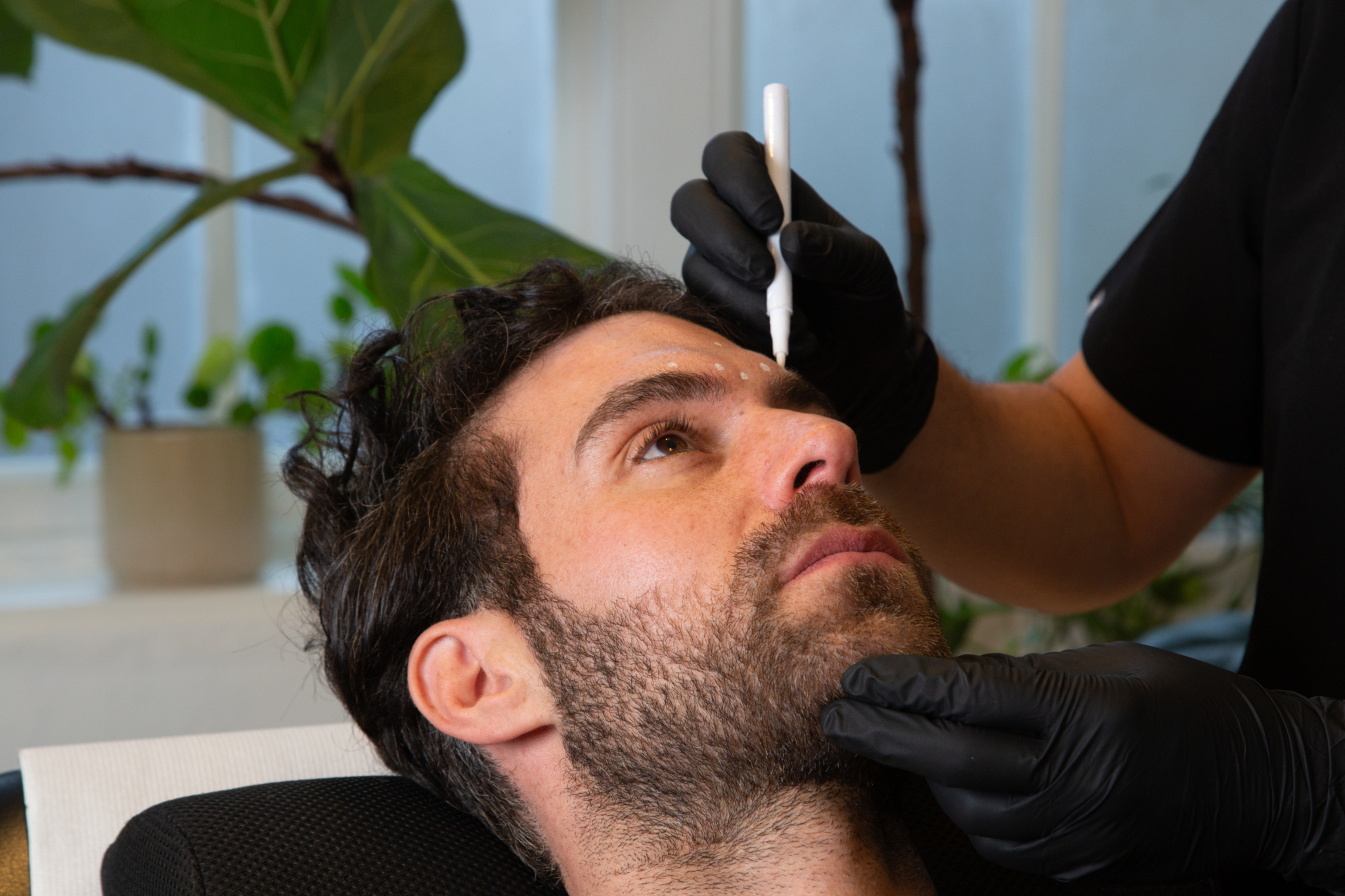 Marco prepares a male client for their polynucleotides treatment
