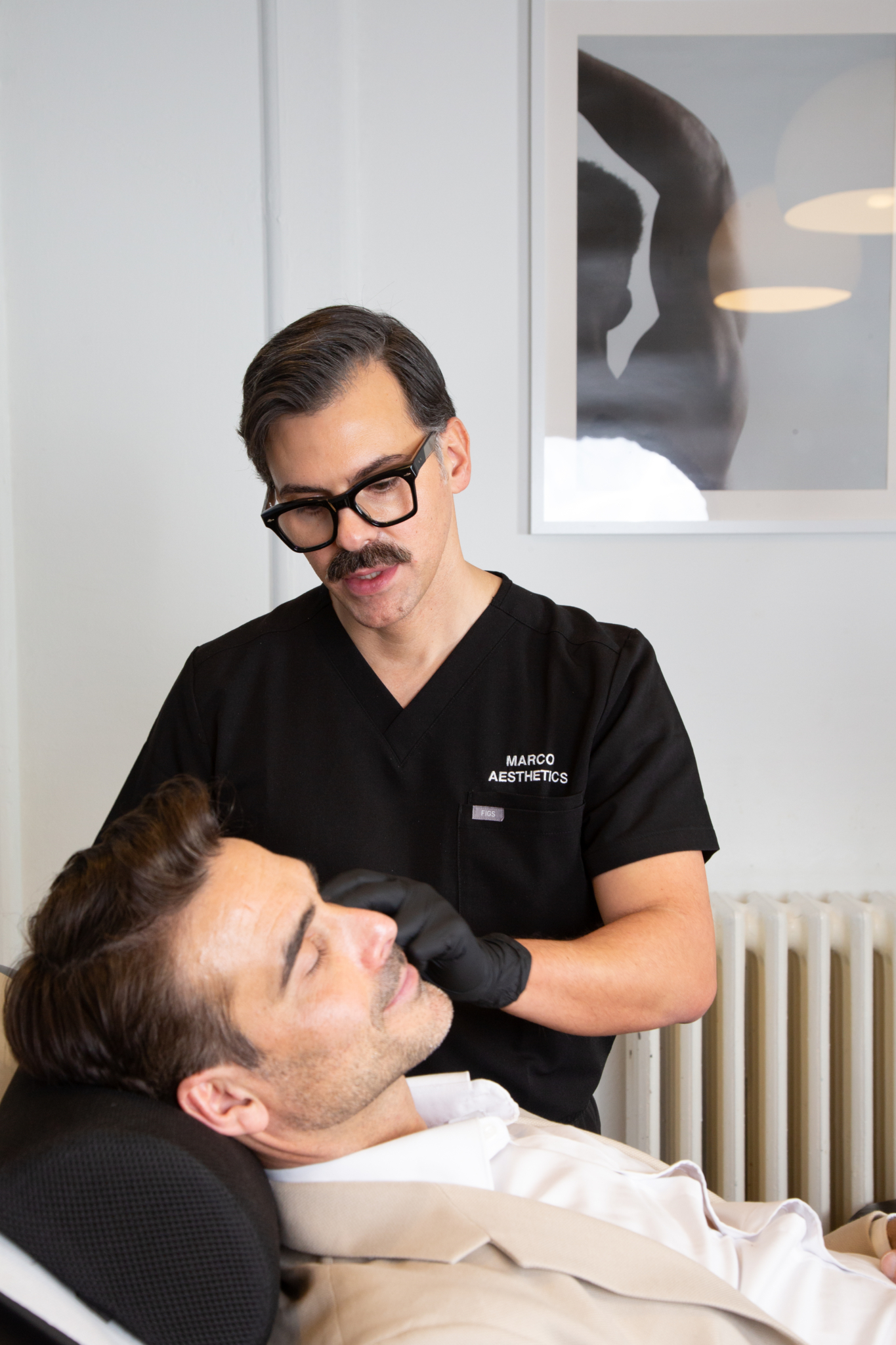 Marco prepares a male client for their temple filler